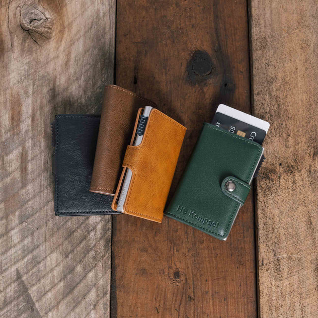 HS Kompact Olive-Green, Light (Tan), Dark and Black wallets on wooden table surface