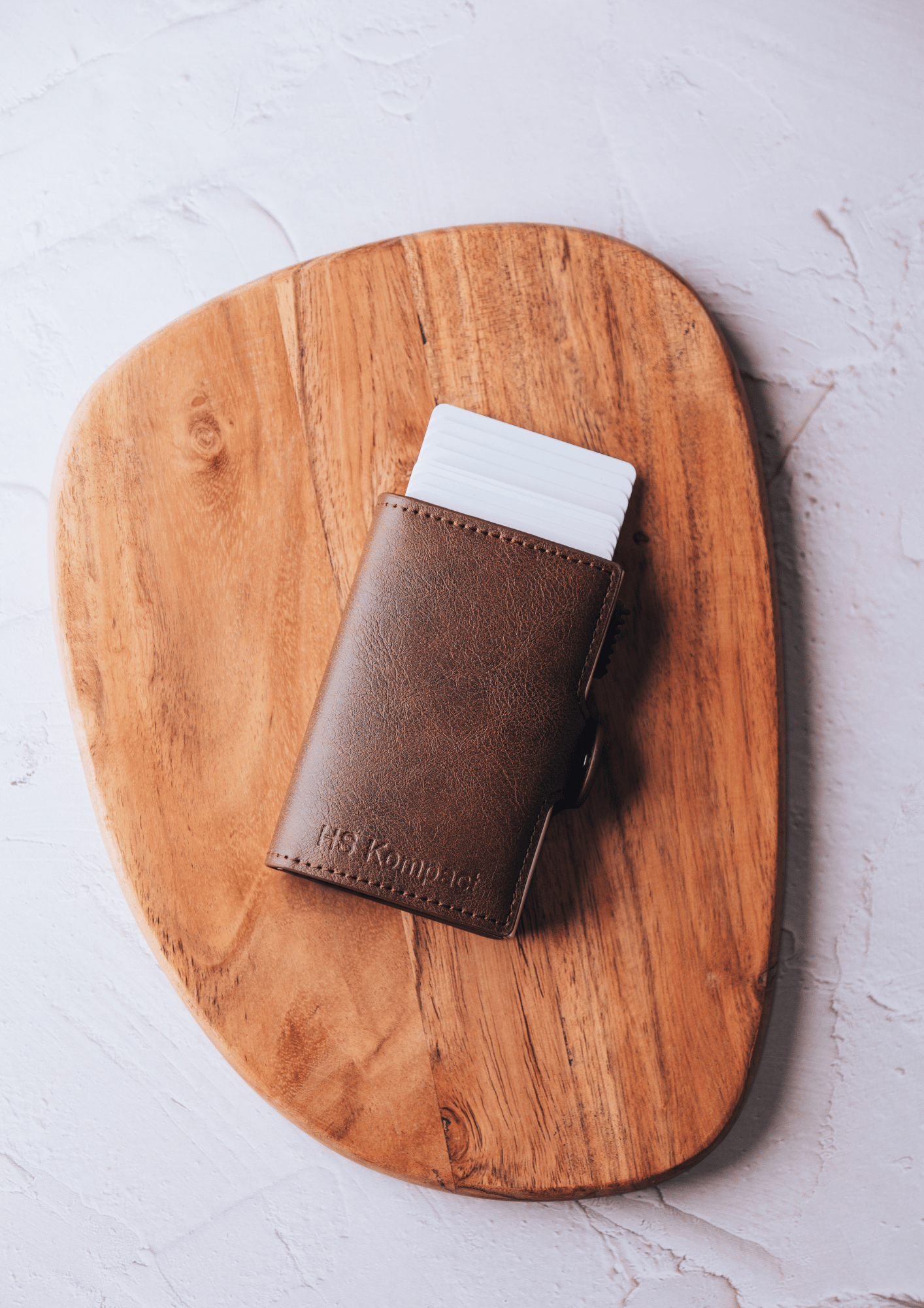 Kompact Stack Dark Brown wallet on wooden board